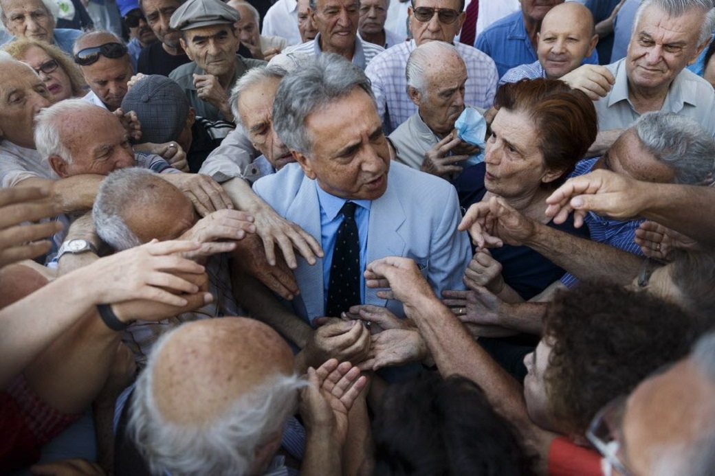 Pensioners try to get a number to enter a bank to get part of their pensions in Athens. 7-1-15. (AP Photo/Daniel Ochoa de Olza)